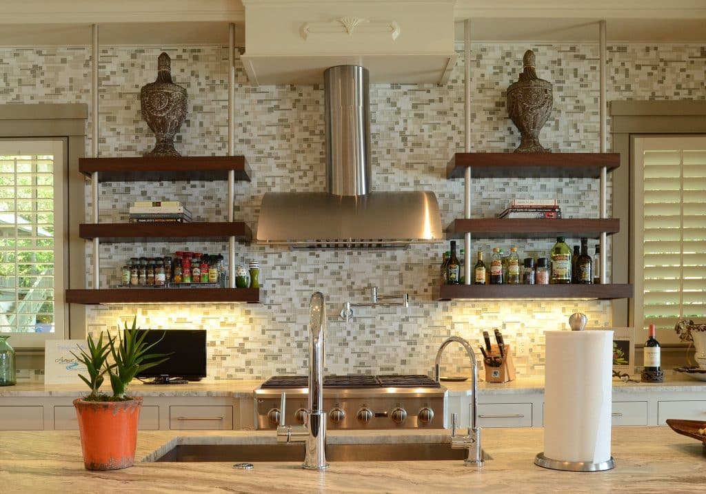 Adams kitchen with tile backsplash and granite countertops designed and constructed by Rita Jones Construction in Northwest Florida