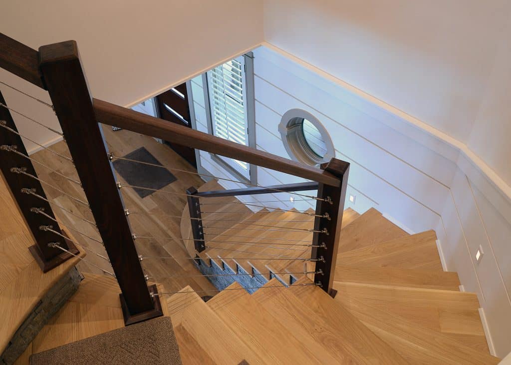 Adams wood winding staircase designed and constructed by Rita Jones Construction in Northwest Florida