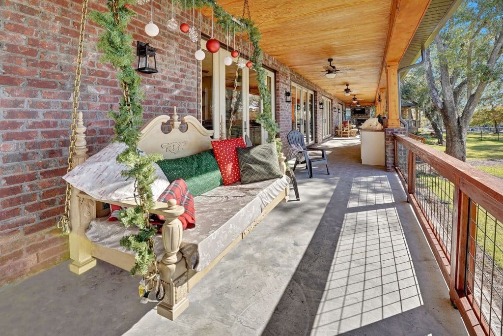 Barros home large back porch with swing designed and constructed by Rita Jones Construction in Panama City Florida