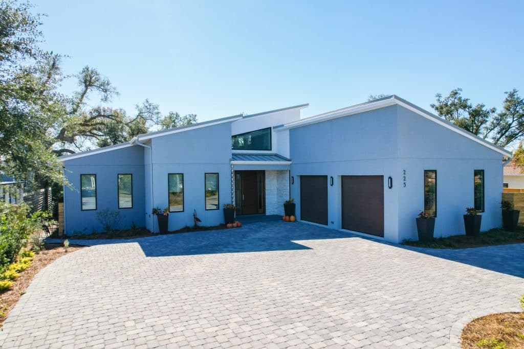New home with two car garage and brick driveway designed and constructed by Rita Jones Construction in Panama City Florida