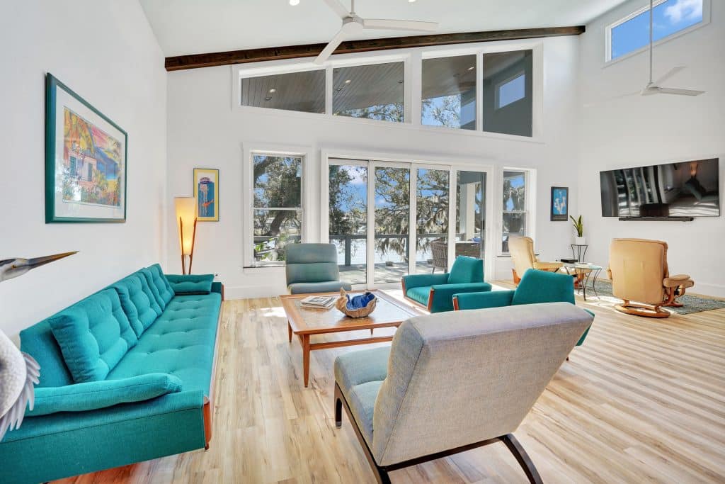 Tubridy grand living room with modernized furnishings and view of the water designed and constructed by Rita Jones Construction in Panama City Florida