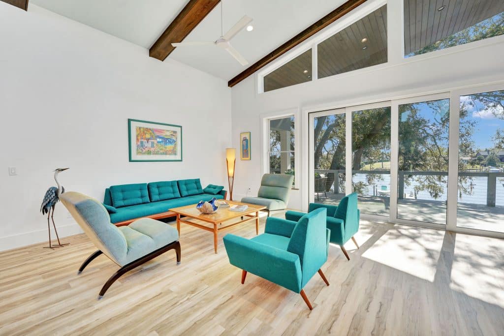 Tubridy grand living room with modernized furnishings and view of the water designed and constructed by Rita Jones Construction in Panama City Florida