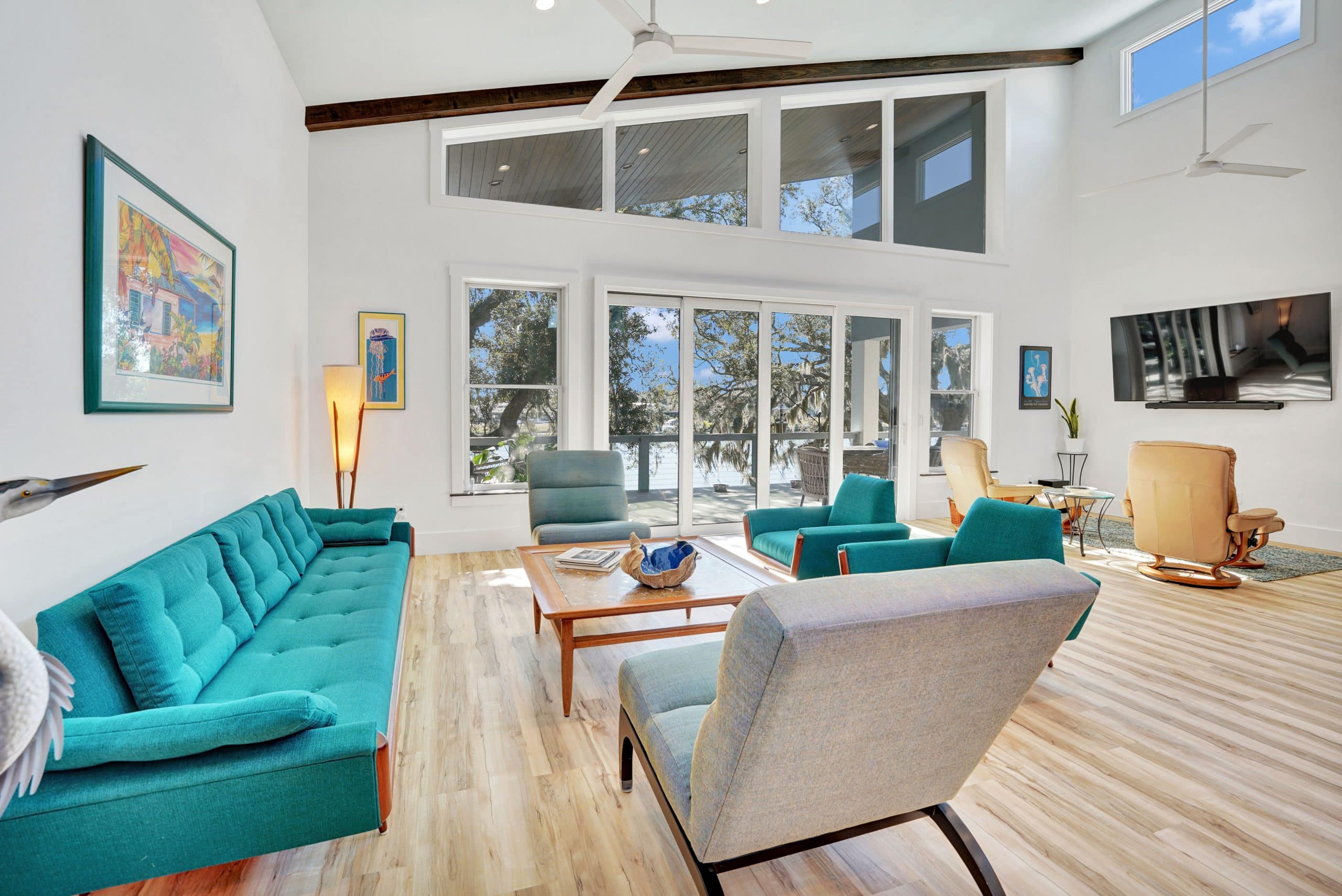 Tubridy grand living room with modernized furnishings and view of the water designed and constructed by Rita Jones Construction in Panama City Florida