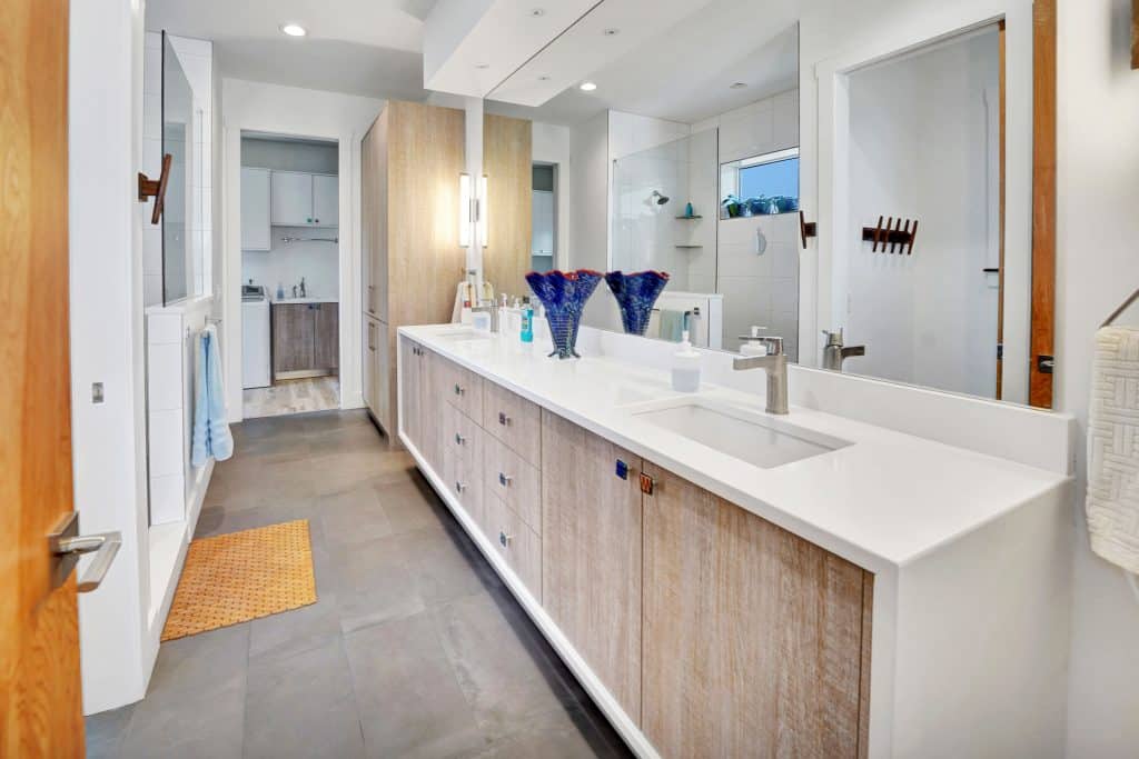Tubridy master bathroom with dual sinks and white countertops designed and constructed by Rita Jones Construction in Panama City Florida